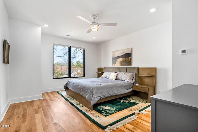 211 W Coporation, Durham, NC 27701 - bedroom with baseboards, light wood-style flooring, recessed lighting, and ceiling fan