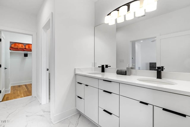 211 W Coporation, Durham, NC 27701 - full bath featuring double vanity, marble look tile flooring, baseboards, and a spacious closet