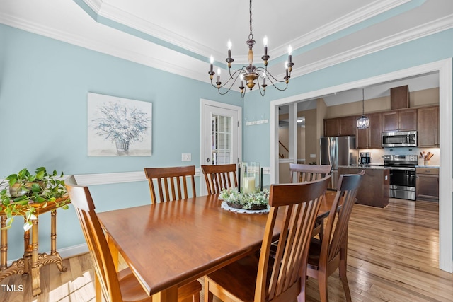1813 Turning Plow Ct, Holly Springs, NC 27540 - dining space with a chandelier, crown molding, and light wood-style flooring