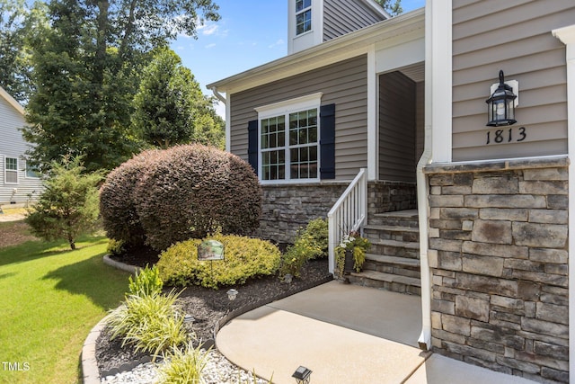 1813 Turning Plow Ct, Holly Springs, NC 27540 - entrance to property featuring stone siding and a lawn