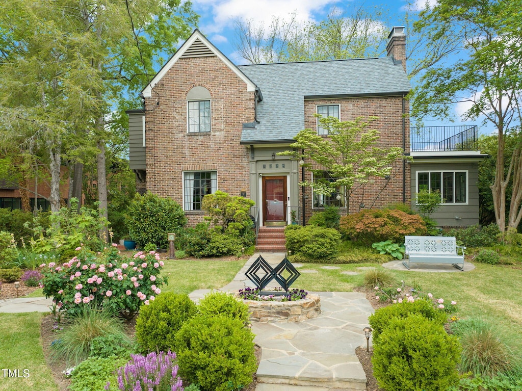 1024 W Markham Ave, Durham, NC 27701 - view of front of property with a chimney, brick siding, roof with shingles, and a balcony