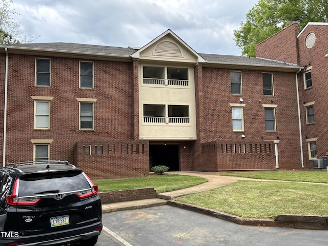 3601 Helix Ct Unit 301, Raleigh, NC 27606 - view of property with central AC unit and uncovered parking