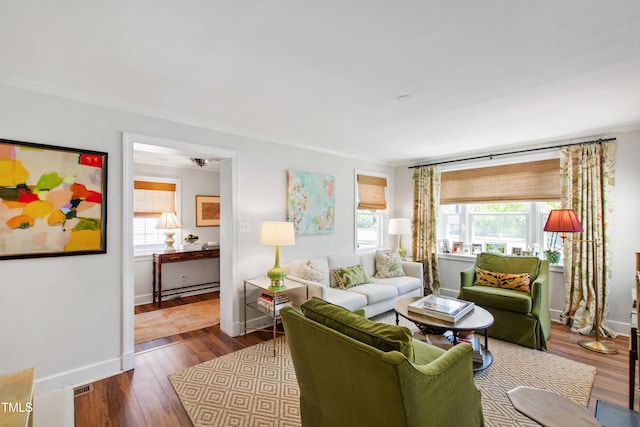 living area featuring baseboards, visible vents, dark wood-style floors, and ornamental molding