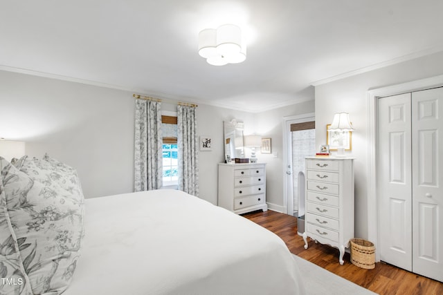 bedroom with a closet, ornamental molding, and wood finished floors