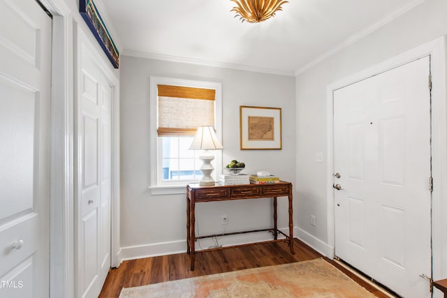 foyer featuring baseboards, ornamental molding, and wood finished floors