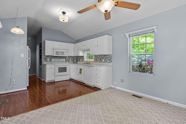 107 Piquot Dr, Louisburg, NC 27549 - kitchen featuring lofted ceiling, light countertops, a sink, white appliances, and white cabinetry