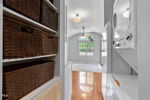 107 Piquot Dr, Louisburg, NC 27549 - clothes washing area with stacked washer and dryer, light wood-style flooring, and laundry area