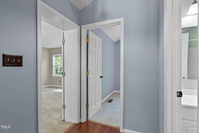 107 Piquot Dr, Louisburg, NC 27549 - hall with baseboards, visible vents, and dark carpet