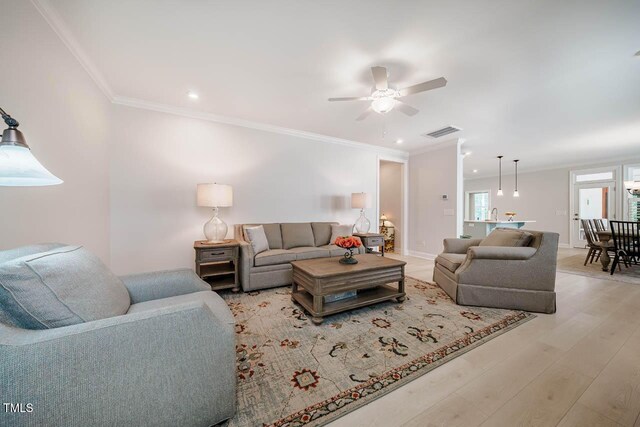83 Vandalia Ave, Chapel Hill, NC 27516 - living room featuring wood finished floors, visible vents, crown molding, and ceiling fan