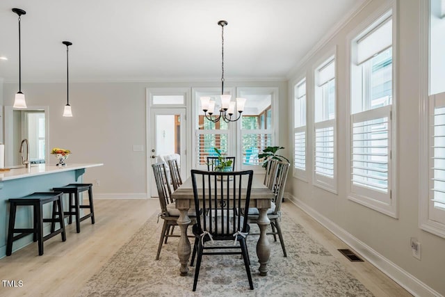 83 Vandalia Ave, Chapel Hill, NC 27516 - dining room featuring crown molding, a chandelier, light wood-style floors, baseboards, and visible vents