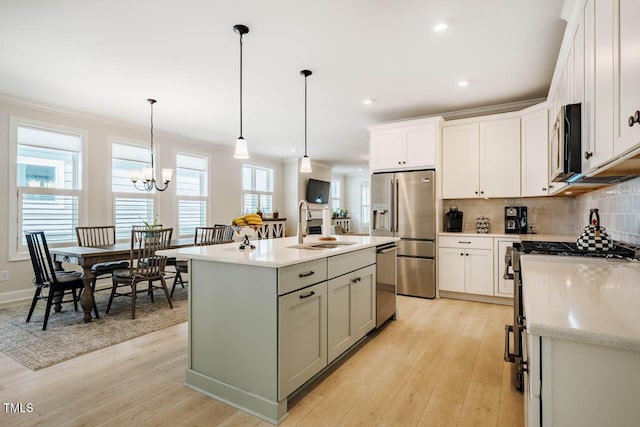 83 Vandalia Ave, Chapel Hill, NC 27516 - kitchen with light wood finished floors, high quality appliances, white cabinetry, and a sink