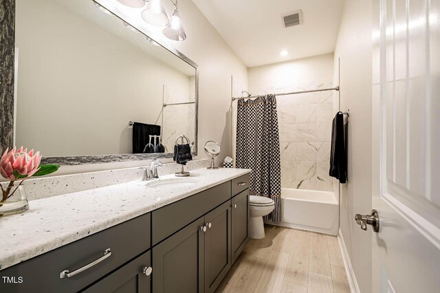 83 Vandalia Ave, Chapel Hill, NC 27516 - full bath featuring toilet, visible vents, shower / bath combo with shower curtain, wood finished floors, and vanity