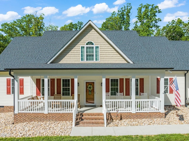 view of front of property with roof with shingles and a porch