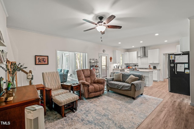 living area featuring recessed lighting, ceiling fan, light wood-style floors, and plenty of natural light