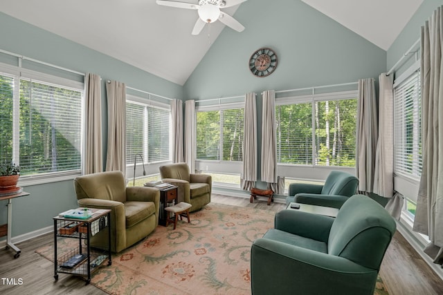 sunroom / solarium with high vaulted ceiling, wood finished floors, and baseboards