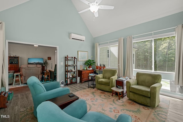 living room with a wall unit AC, high vaulted ceiling, a healthy amount of sunlight, a ceiling fan, and wood finished floors