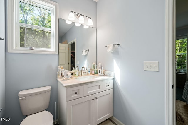 bathroom featuring toilet and vanity