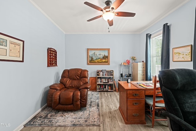 home office featuring ornamental molding, a ceiling fan, baseboards, and light wood-style floors