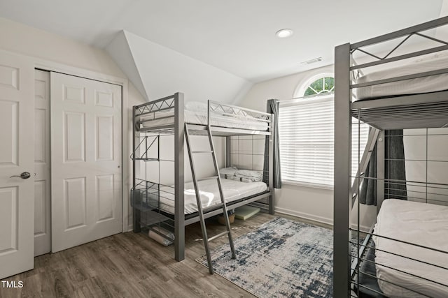 bedroom featuring recessed lighting, visible vents, vaulted ceiling, baseboards, and wood finished floors