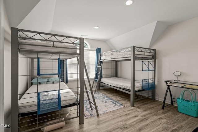 bedroom with baseboards, recessed lighting, wood finished floors, and vaulted ceiling