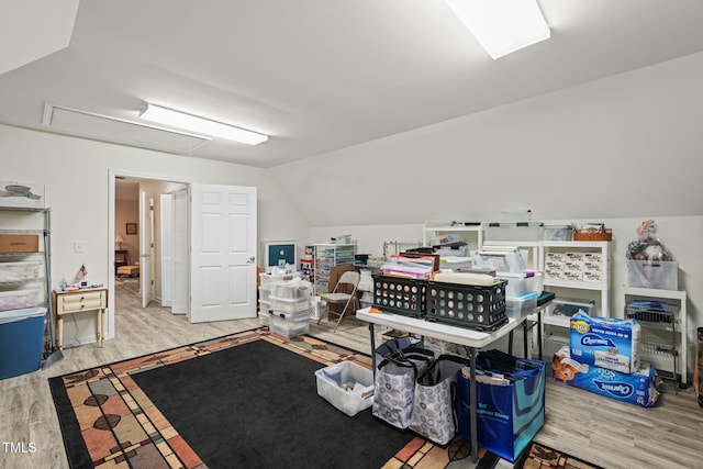 interior space featuring lofted ceiling and wood finished floors