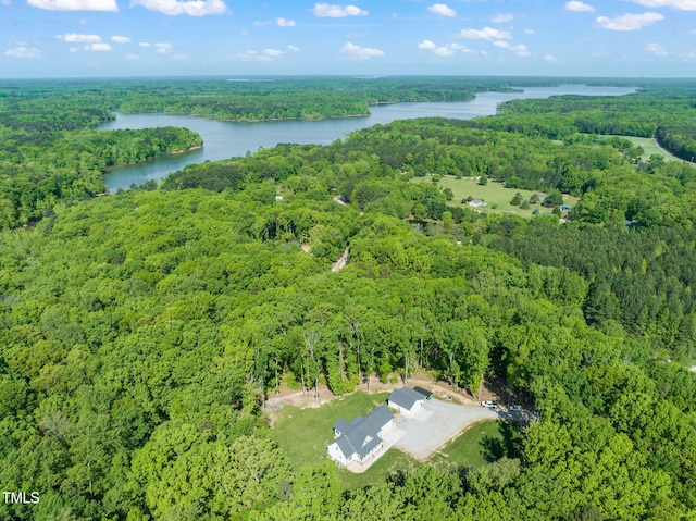 aerial view featuring a water view and a wooded view