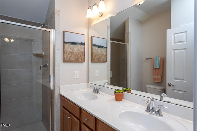 bathroom featuring toilet, a shower stall, and double vanity