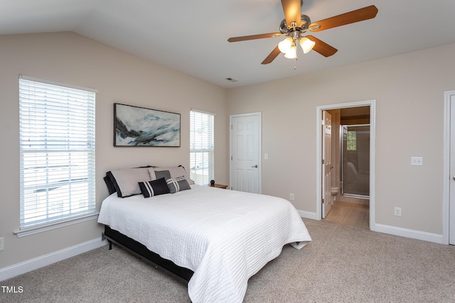 bedroom with multiple windows, light colored carpet, baseboards, and vaulted ceiling