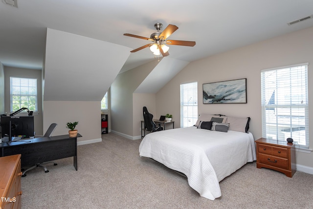 bedroom featuring light colored carpet, a desk, baseboards, lofted ceiling, and a ceiling fan