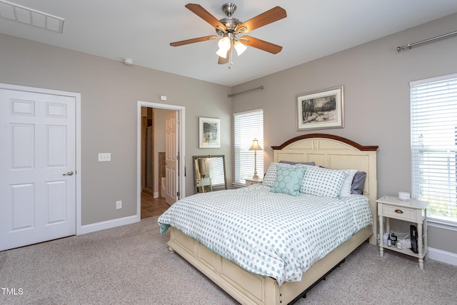 bedroom with light colored carpet, baseboards, and ceiling fan