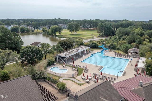 aerial view of a pool area and a nearby body of water