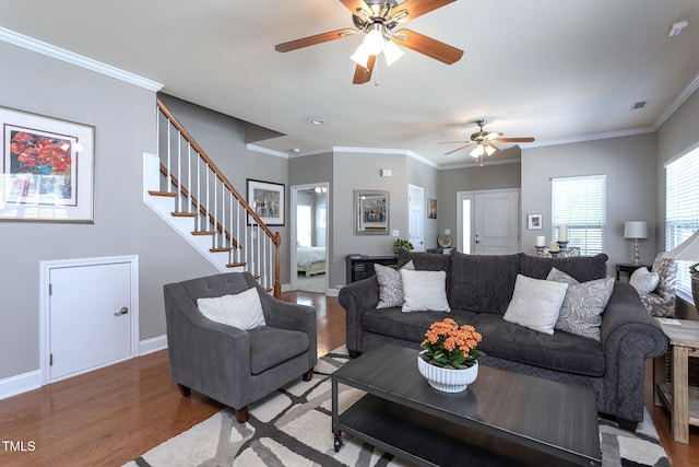 3827 Heritage Spring Cir, Wake Forest, NC 27587 - living area featuring wood finished floors, a ceiling fan, stairs, ornamental molding, and baseboards
