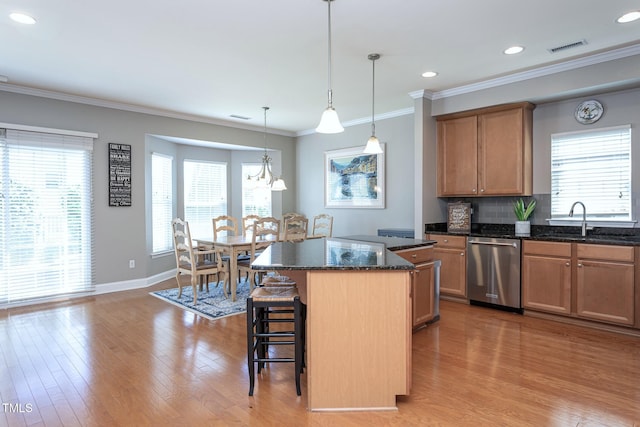 3827 Heritage Spring Cir, Wake Forest, NC 27587 - kitchen featuring dishwasher, a sink, a kitchen bar, a center island, and light wood-style floors