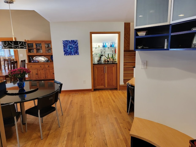 dining room featuring light wood-style floors and baseboards