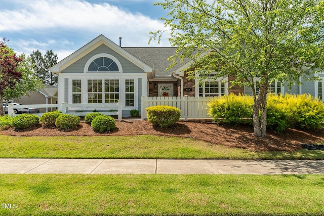 view of front of property with a shingled roof and stone siding