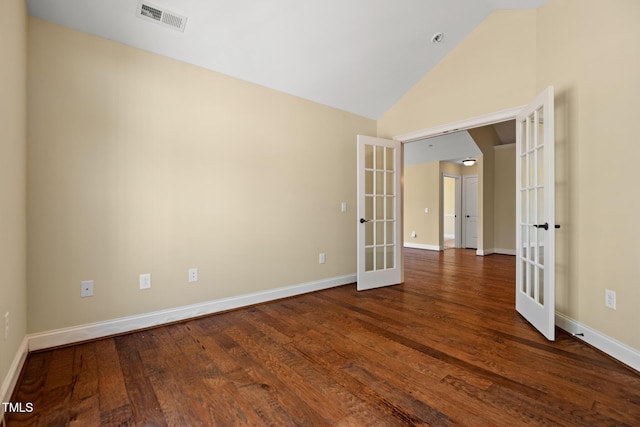 spare room with french doors, dark wood-style floors, baseboards, and high vaulted ceiling