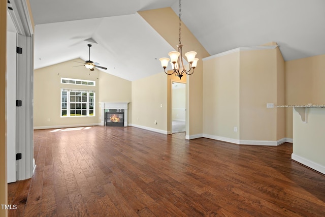 unfurnished living room featuring a ceiling fan, vaulted ceiling, dark wood finished floors, a chandelier, and a glass covered fireplace