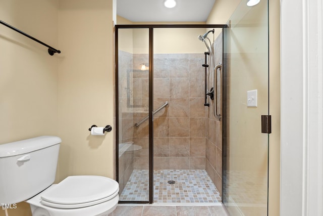 full bath with a shower stall and toilet