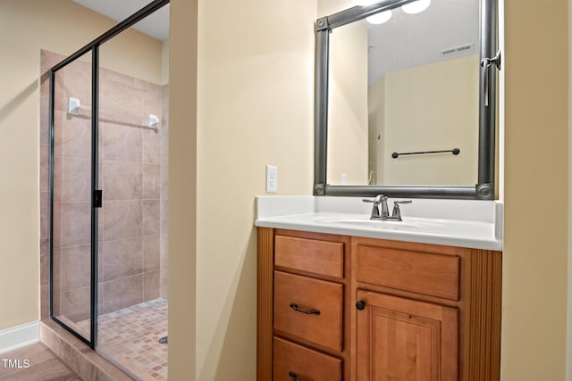 bathroom featuring a shower stall and vanity