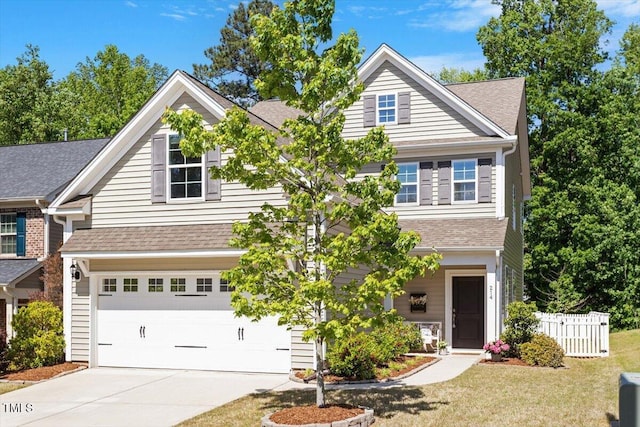 craftsman house featuring a garage, fence, a shingled roof, and concrete driveway
