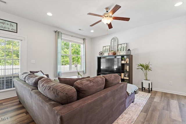 living area with a ceiling fan, visible vents, baseboards, recessed lighting, and dark wood-type flooring