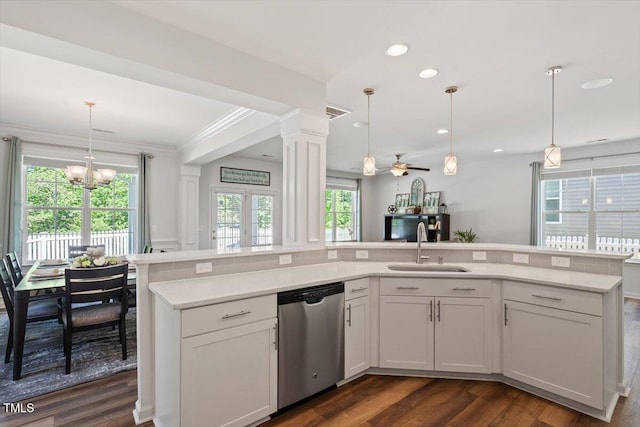 kitchen with stainless steel dishwasher, a sink, a healthy amount of sunlight, and light countertops