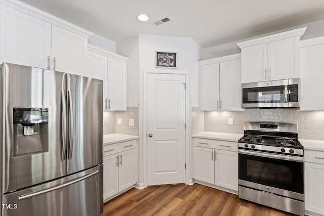 kitchen featuring light countertops, white cabinetry, appliances with stainless steel finishes, and dark wood-style floors