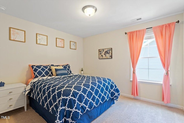 carpeted bedroom featuring visible vents and baseboards