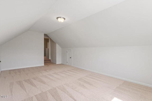 bonus room with carpet flooring, baseboards, and vaulted ceiling