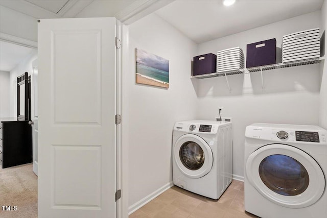 laundry area with laundry area, baseboards, and washer and dryer