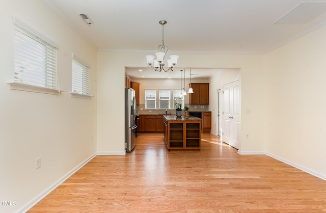 1522 Palmer Hill Dr, Durham, NC 27703 - kitchen featuring visible vents, light wood-style floors, stainless steel refrigerator with ice dispenser, a chandelier, and brown cabinets
