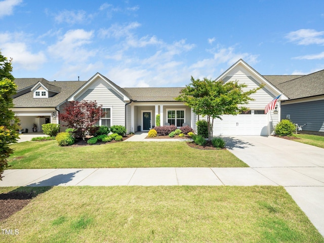 view of front of house featuring a garage, driveway, and a front yard