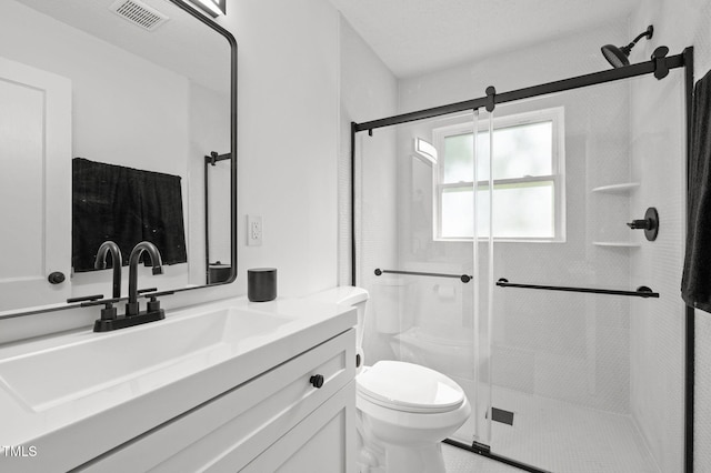 1613 Kilmer Ter, Durham, NC 27703 - bathroom featuring toilet, visible vents, a shower stall, and vanity