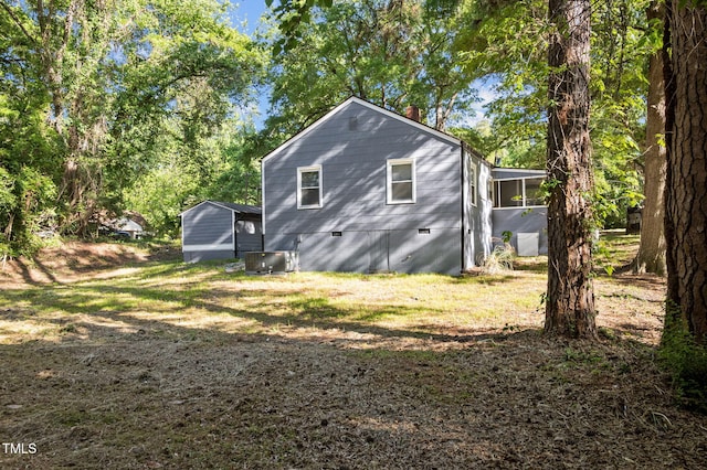 1613 Kilmer Ter, Durham, NC 27703 - view of side of property featuring a chimney, a sunroom, central air condition unit, and crawl space